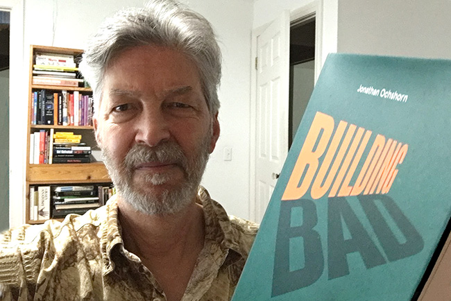 Jonathan Ochshorn holding his book, Building Bad