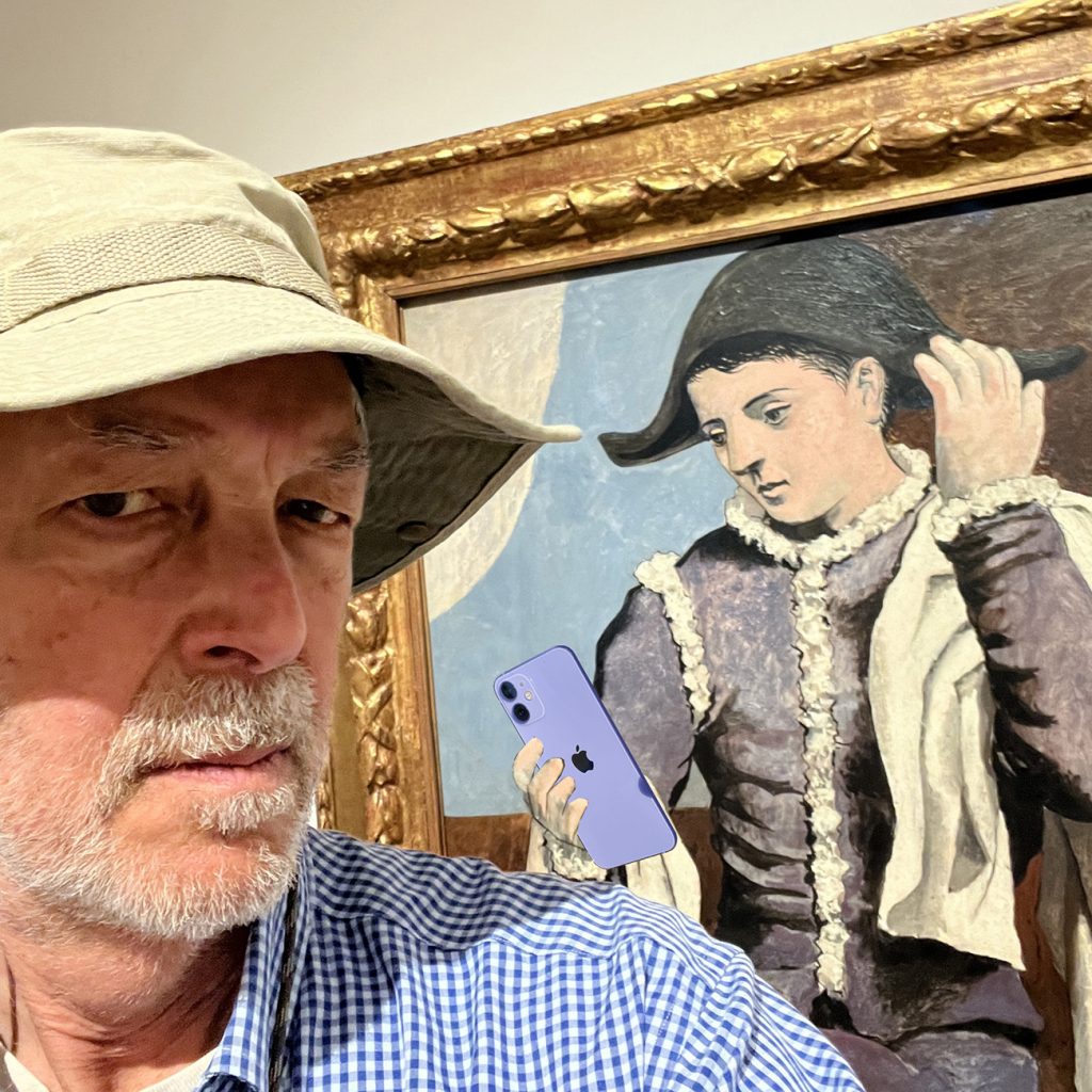 Selfie taken in front of Picasso's 1923 Harlequin with a Mirror, with the "harlequin" taking a selfie at the same time, courtesy of PhotoShop.