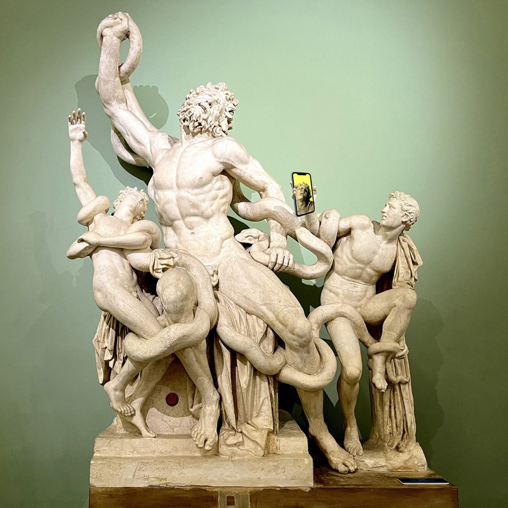 Plaster cast of statue of Laocoön and His Sons, edited with PhotoShop to include iPhone (as if one of the figures, in anguish, is taking a selfie.